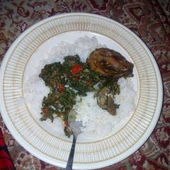 A picture of White rice and vegitable soup with fish.