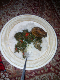 A picture of White rice and vegitable soup with fish.
