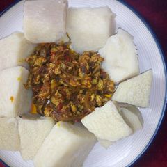 A picture of Cooked yam with Egg sauce.