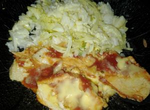Una foto de Pechuga de Pollo con ketchup y ensalada de arroz con cebolla