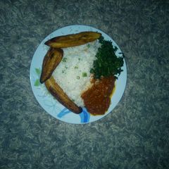 White rice, vegetable, stew and plantain A picture of White rice, vegetable, stew and plantain.