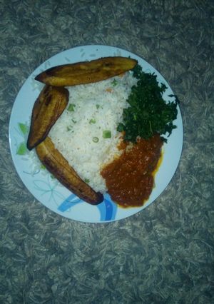 A picture of White rice, vegetable, stew and plantain.