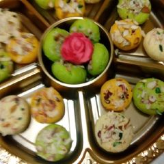 A picture of Almond burfi Different colours and shapes of burfis.