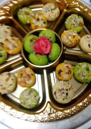 A picture of Almond burfi Different colours and shapes of burfis.
