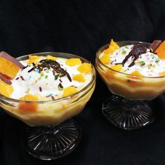 A picture of Mango Mix Fruit Custard with Vanilla Ice Cream.