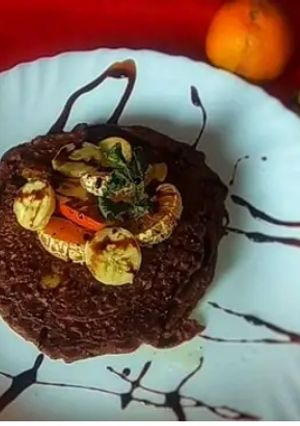 A picture of Chocolate Banana Peanut Fruit Pancake With Choco Sauce.