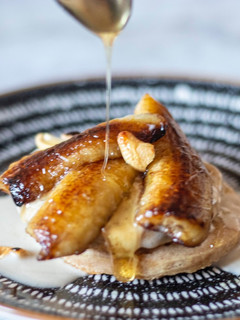 A picture of Pancake With Banana in coconut milk and roasted cashew nut.