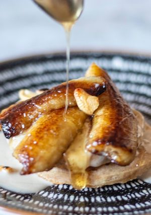 A picture of Pancake With Banana in coconut milk and roasted cashew nut.