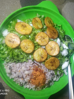 A picture of Rice and beans with salad.