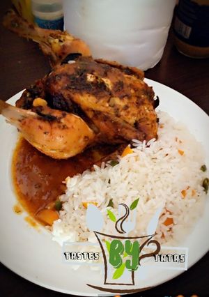 A picture of White rice with roasted chicken.