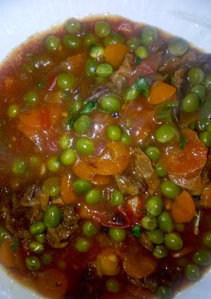 A picture of Beef stew with peas.
