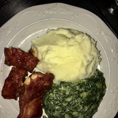 A picture of Pork ribs, mash potatoes and cream spinach.