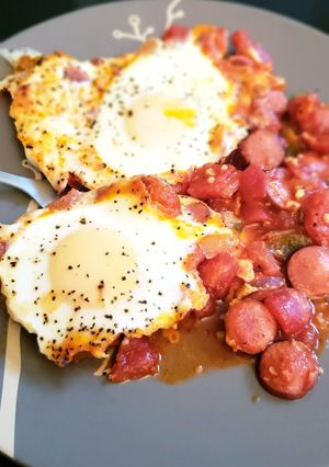 A picture of Shakshuka with hot dogs.
