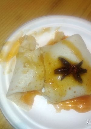 A picture of Anjeerii Dosaa with orange sauce.
