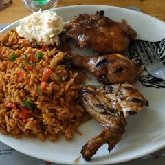 A picture of Jollof rice with grilled chicken.
