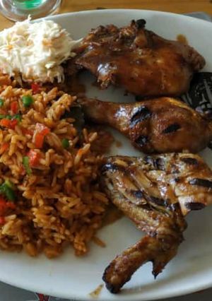 A picture of Jollof rice with grilled chicken.