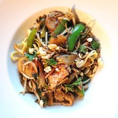 A picture of Shredded chicken with black bean and veg noodles.