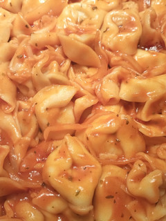 Una foto de Tortelloni rellenos de carne en tomate
