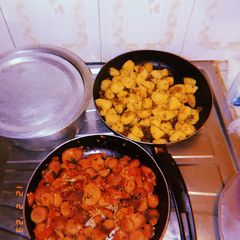A picture of Pan fried potatoes and sausages.