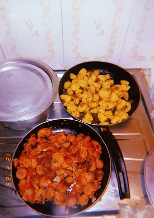 A picture of Pan fried potatoes and sausages.