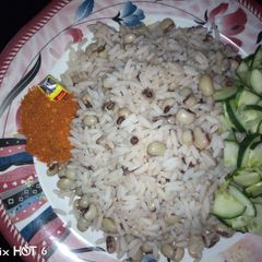 A picture of Rice n beans wit cucumber.