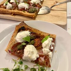 A picture of Roasted Tomato Tart with Ricotta and Pesto.