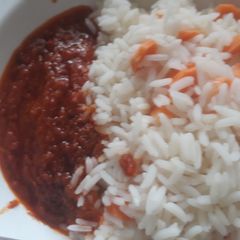 A picture of Carrot rice with tomato stew.