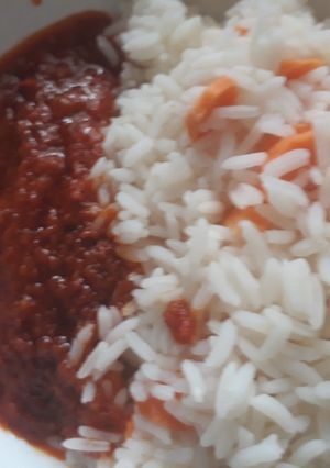 A picture of Carrot rice with tomato stew.