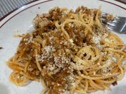 A picture of pork and spaghetti in tomato sauce