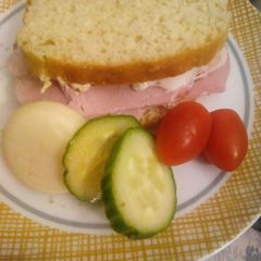 A picture of Small ham sandwich with light Philadelphia.