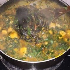 A picture of Yam porriage with vegetable and dry fish.