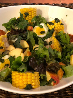 A picture of Salad: Garden Greens with Apple, Sweet Corn, basil pesto and Soft Boiled Eggs.