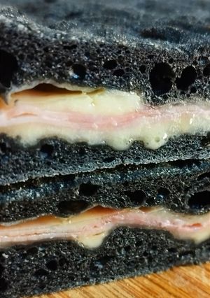 A picture of Charcoal Focaccia Stuffed with Cheese and Ham 🧀🥓.