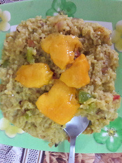 A picture of Moong dal khichdi with onion tomato and capsicum tadka.