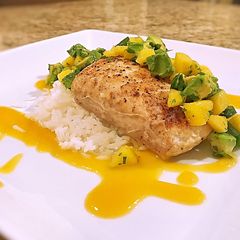 A picture of Pan seared halibut on coconut rice with mango peach habanero sauce and mango avocado salsa.