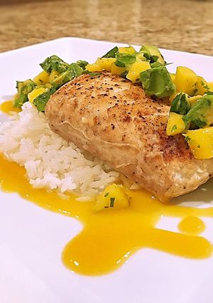 A picture of Pan seared halibut on coconut rice with mango peach habanero sauce and mango avocado salsa.