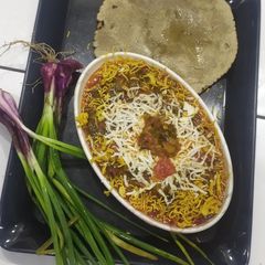 A picture of Cheesy spring onion sev sabji.
