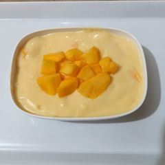 A picture of Vanilla custard with mango cubes 🥭🍨.