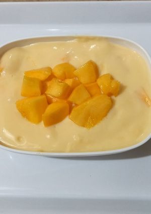 A picture of Vanilla custard with mango cubes 🥭🍨.