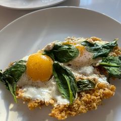 A picture of Eggs Fried in Parmesan Breadcrumbs with Wilted Spinach.