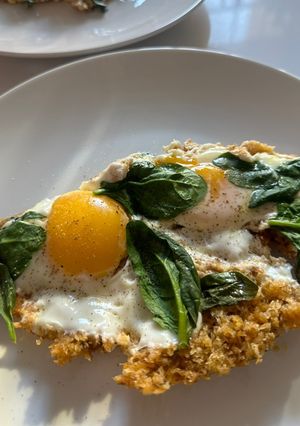A picture of Eggs Fried in Parmesan Breadcrumbs with Wilted Spinach.