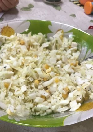 A picture of Salad with corn.