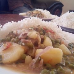 A picture of Peas mixed with meat and potatoes.