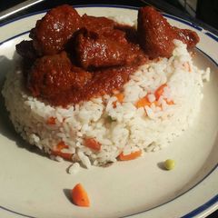 A picture of Veggie rice served with offals stew.