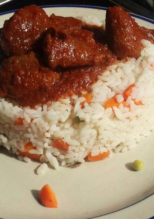 A picture of Veggie rice served with offals stew.