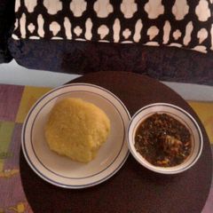 A picture of Vegetable soup with goat meat and Eba(Garri).