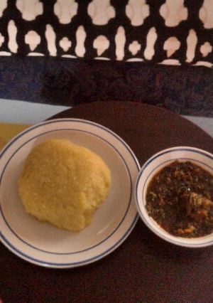 A picture of Vegetable soup with goat meat and Eba(Garri).