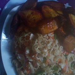 A picture of Indomie with egg sauce and plantain.