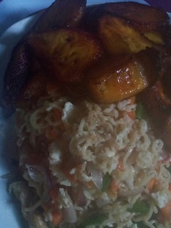 A picture of Indomie with egg sauce and plantain.