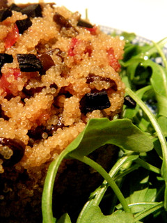 Una foto de Ensalada caliente de amaranto y senderuelas con jamón ibérico y ajo negro